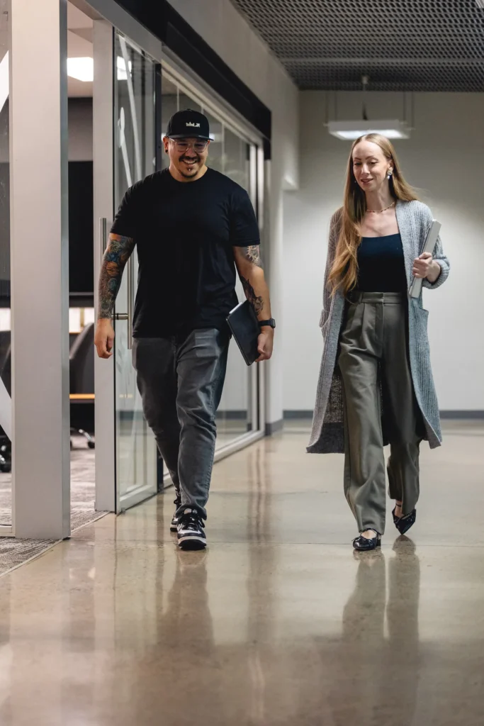 A&H directors talking and laughing while walking down hallway