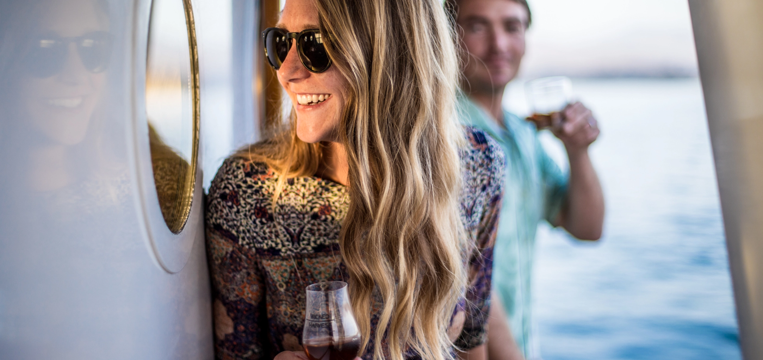 Wicked Harvest Spirits couple drinking bourbon on a yacht